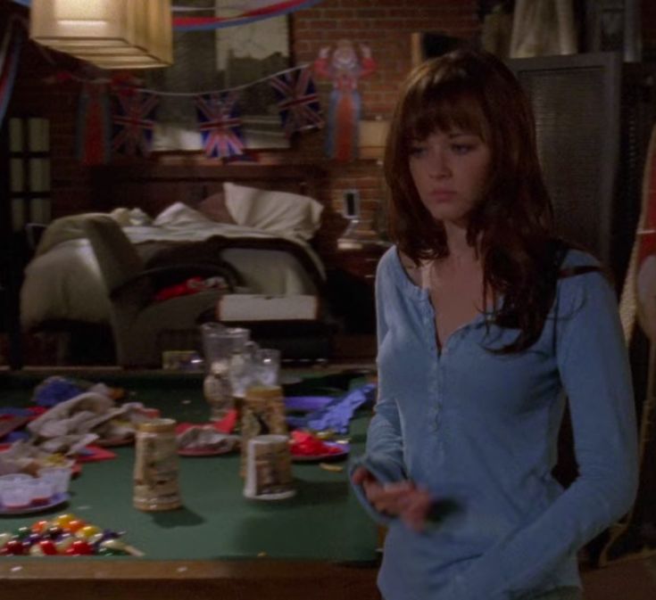 a woman standing in front of a table full of candy