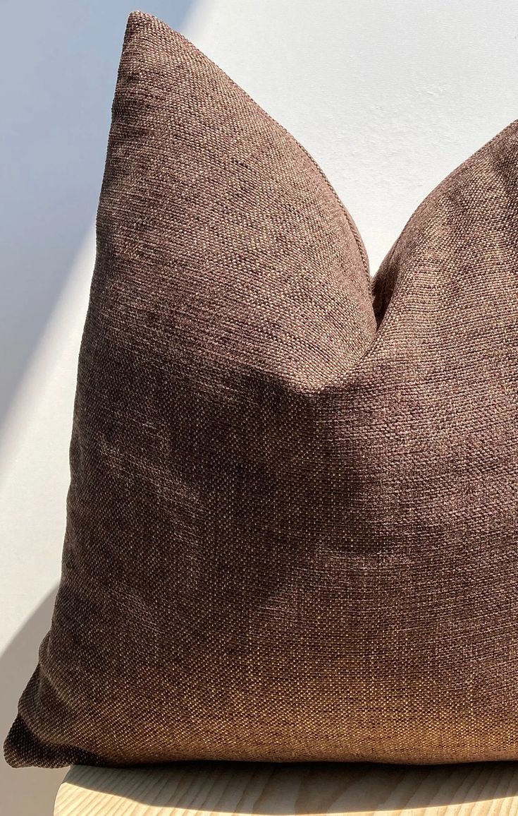 a brown pillow sitting on top of a wooden table