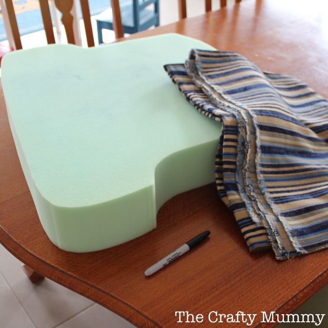 a cutting board sitting on top of a wooden table next to a pair of scissors