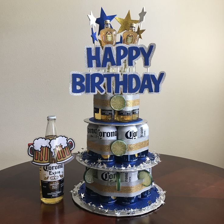 a birthday cake made out of beer cans on top of a table next to a bottle