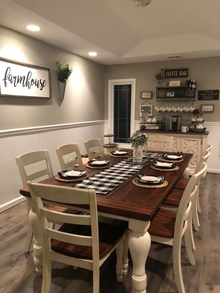 the dining room table is set with place settings for eight people, and there is a sign on the wall above it