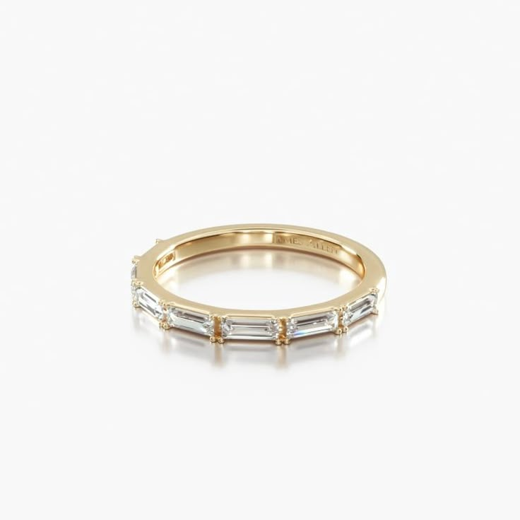 a yellow gold band with three baguettes on the side, set in white diamonds