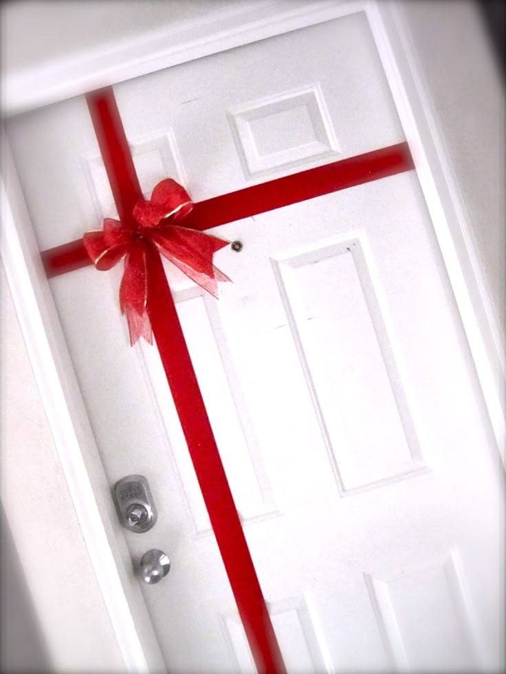 a white door with a red ribbon on it