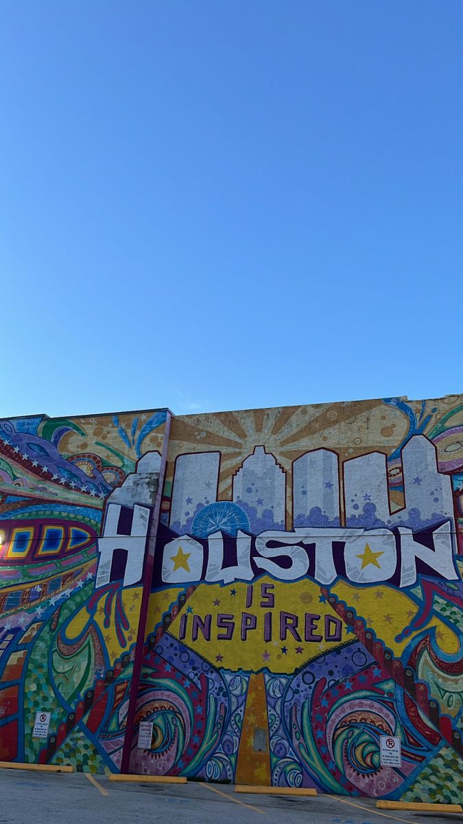 a mural on the side of a building that says houston is inspired by colorful designs