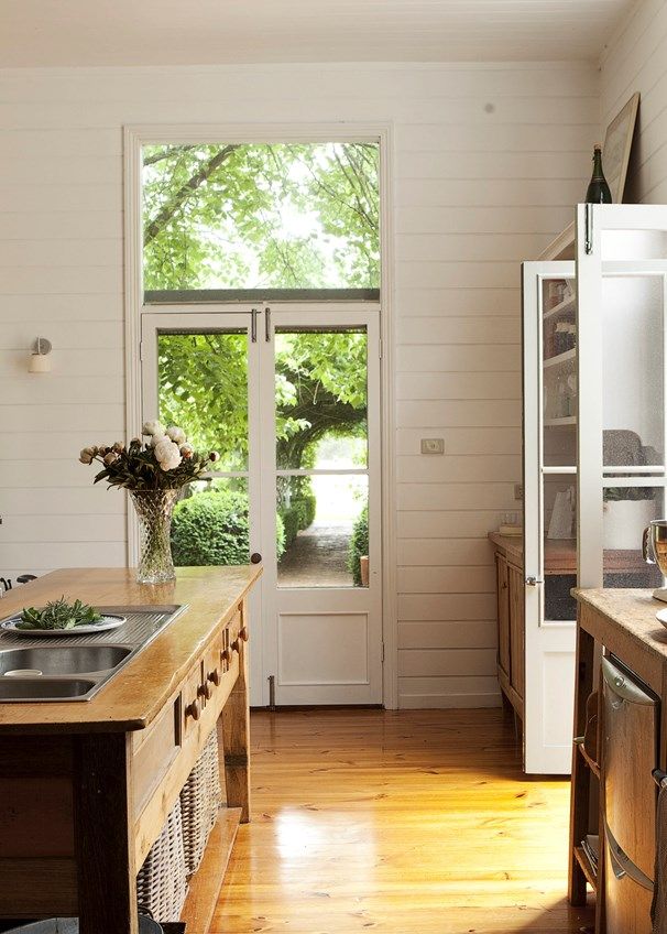 the kitchen is clean and ready for us to use it's counter tops are made out of wood