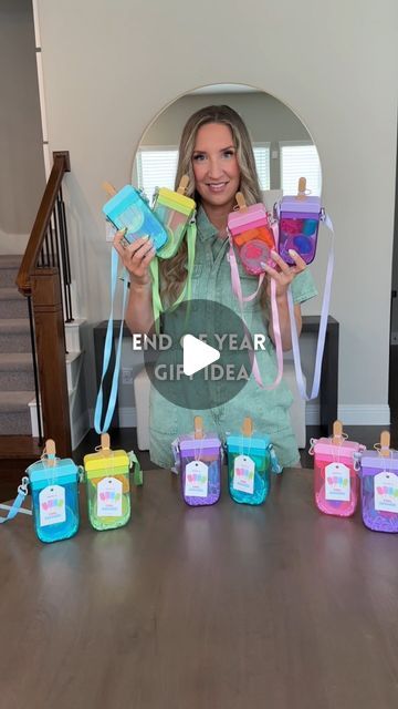 a woman is holding up some baby items in front of her and the words end year gift ideas