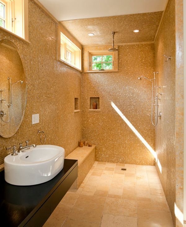 a bathroom with a sink, mirror and shower stall in it's center area