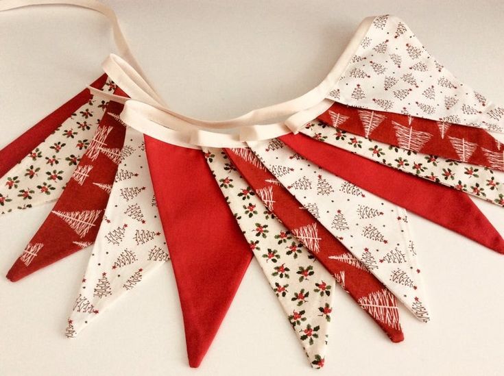 a red and white christmas banner hanging from a string