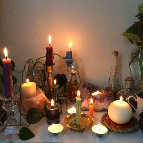 a table topped with candles and other items