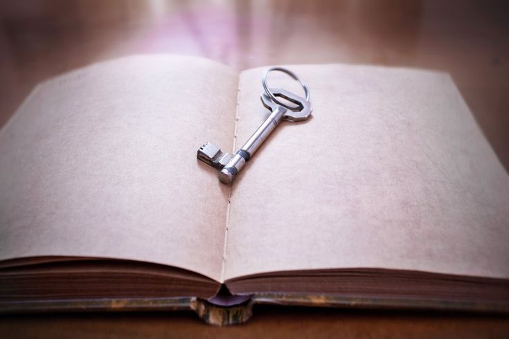 an open book with a key on it