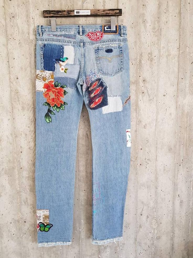 a pair of jeans with patches and flowers on them