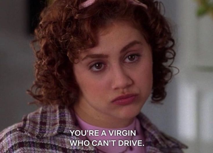 a woman with curly hair wearing a pink shirt and jacket in the movie you're a virgin who can't drive