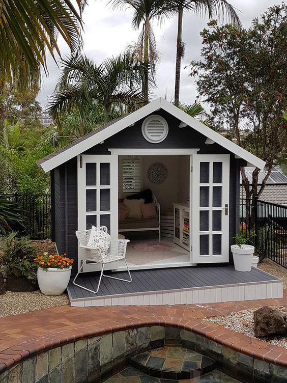 a small backyard shed with a pool in the middle