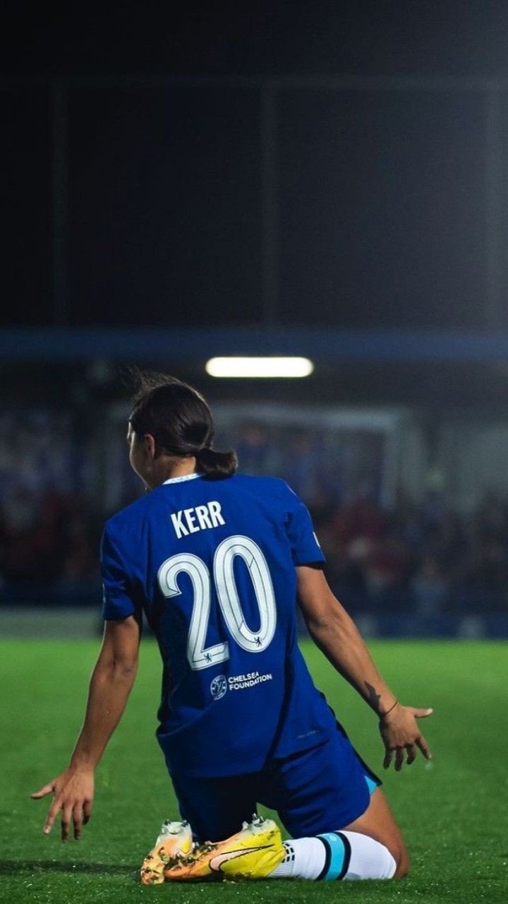 a female soccer player sitting on the ground