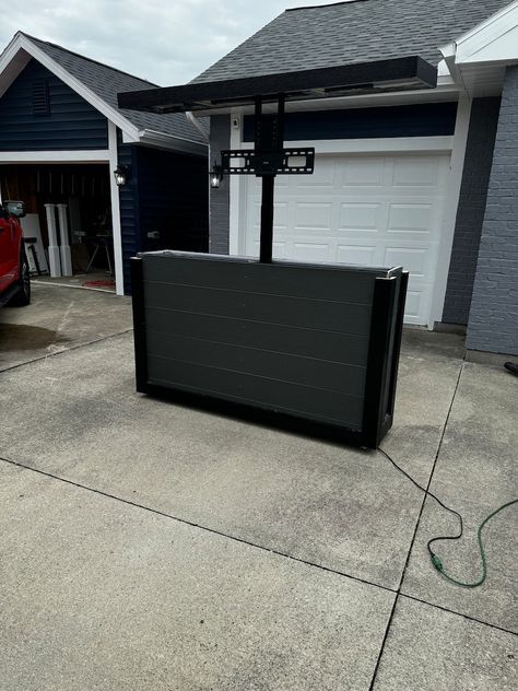 a large black box sitting in front of a garage