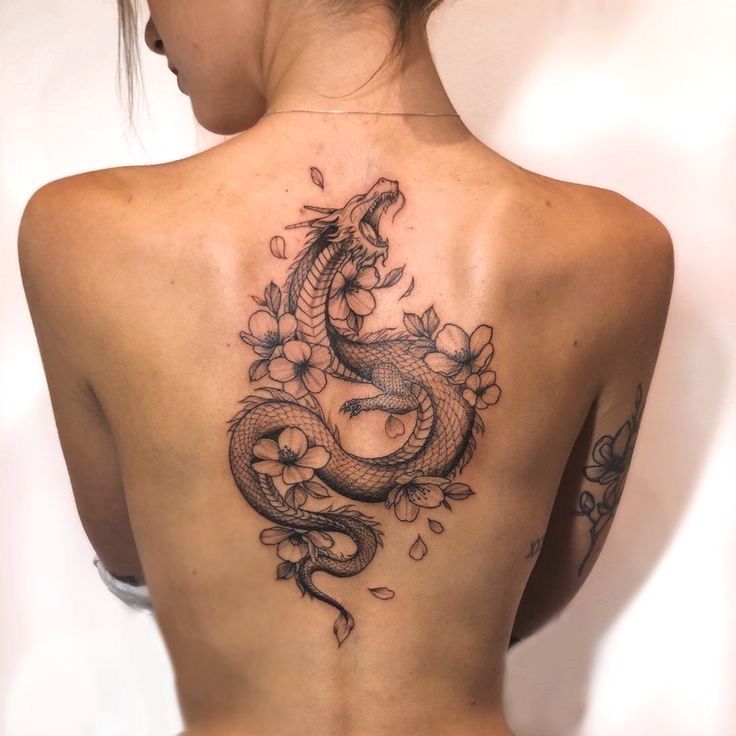 a woman with a dragon tattoo on her back