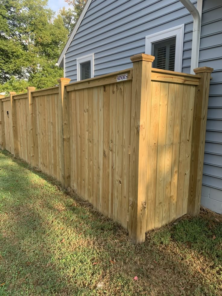 a wooden fence in front of a house