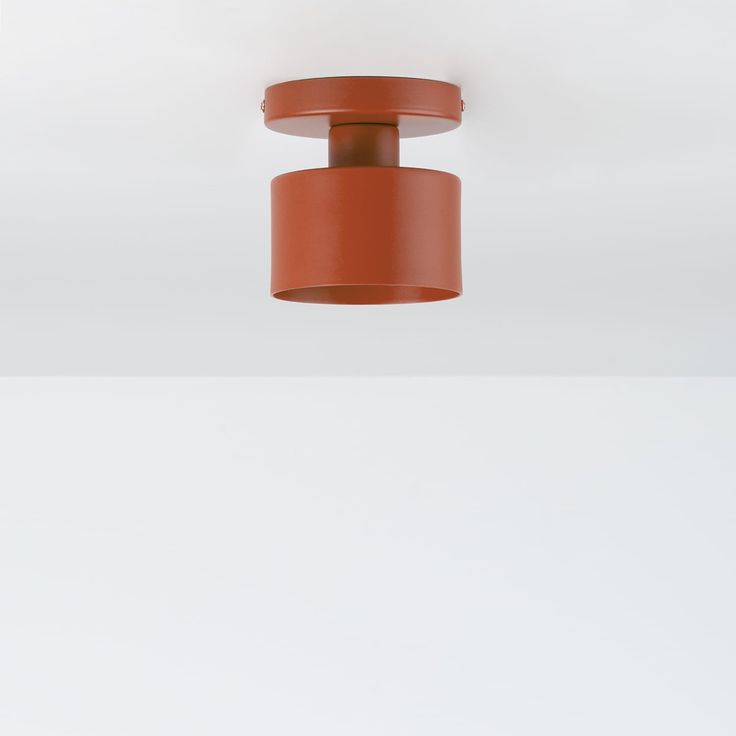 an orange light fixture hanging from the ceiling