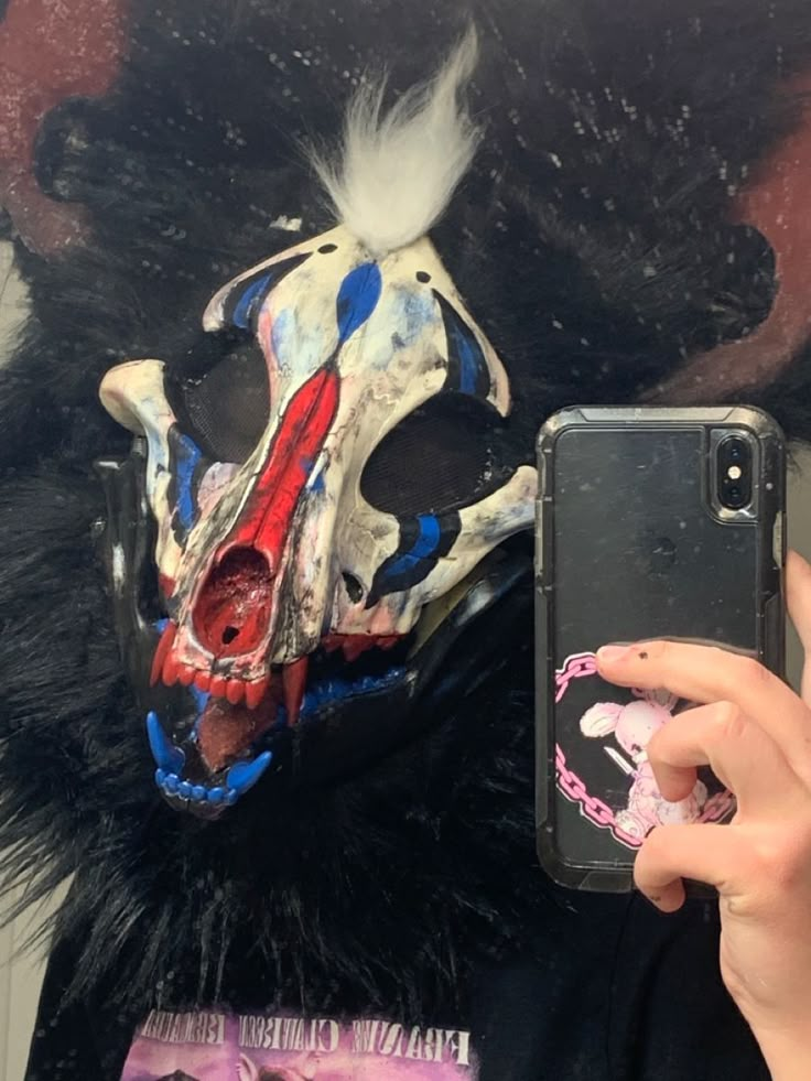 a person taking a selfie in front of a mask