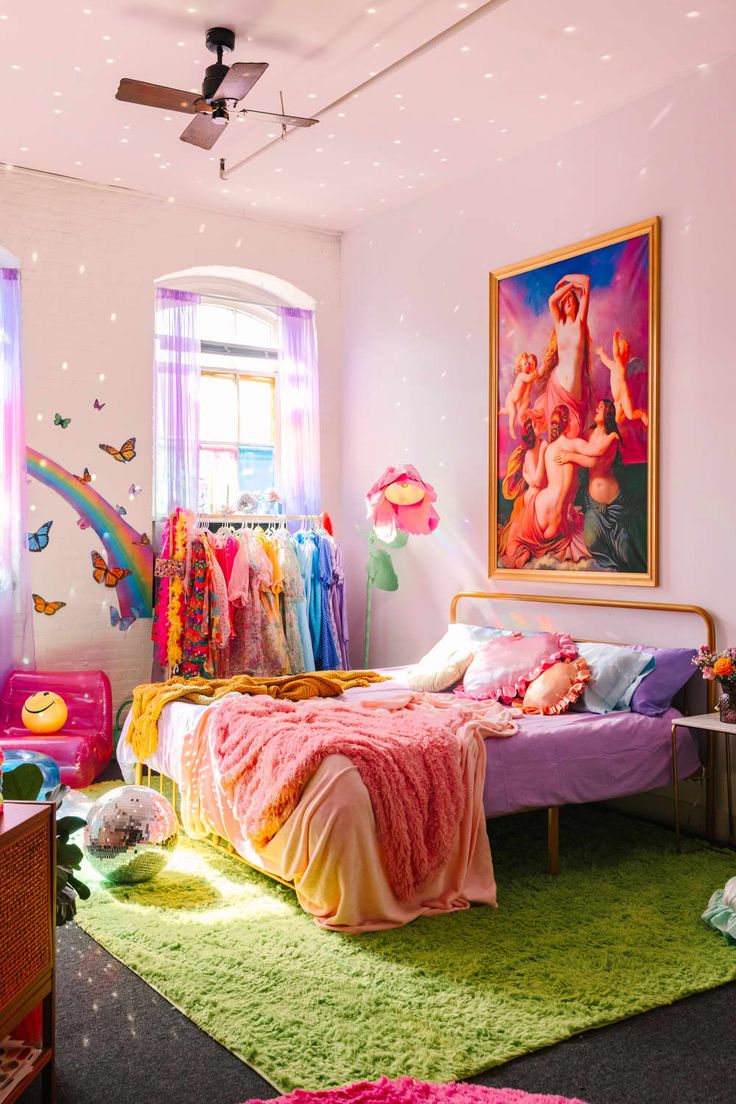 a bedroom decorated in pastel colors with pink, yellow and green accents on the walls