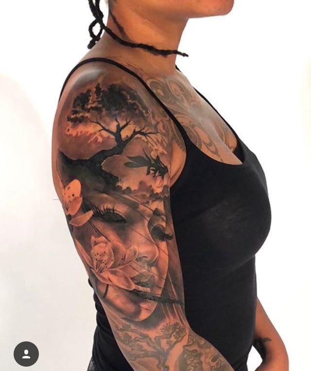 a woman with tattoos on her arm and shoulder