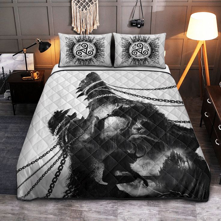 a bed covered in a black and white pirate themed comforter set with two pillows