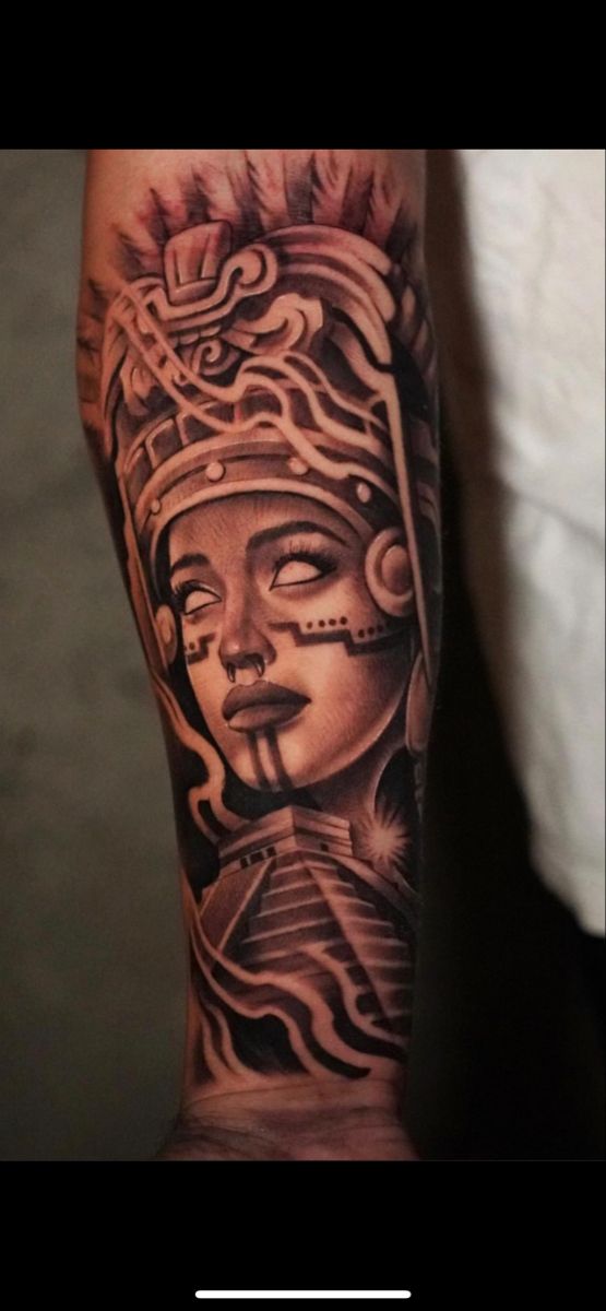 a person with a tattoo on their arm and head in the shape of a mask