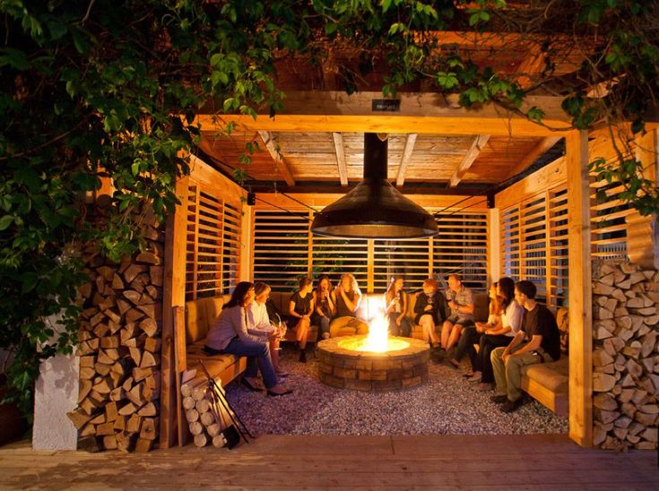 a group of people sitting around a fire pit