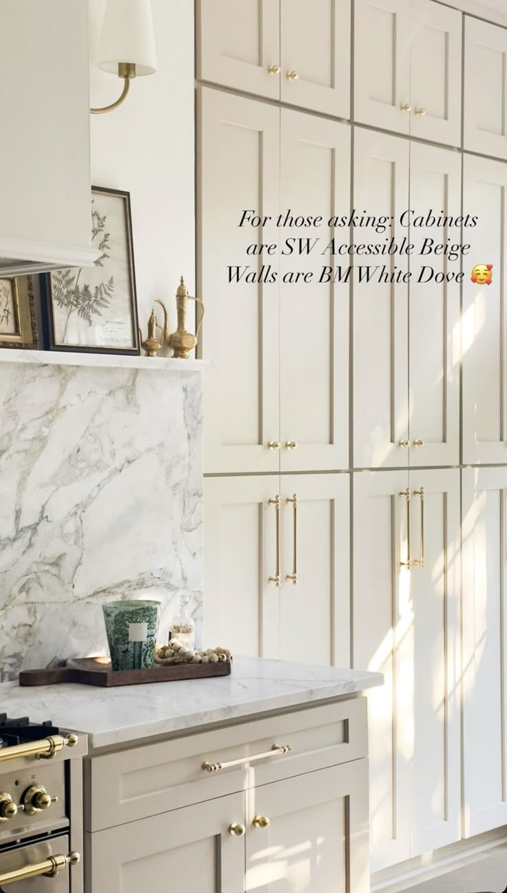 a kitchen with white cabinets and marble counter tops in the center is an image of a clock