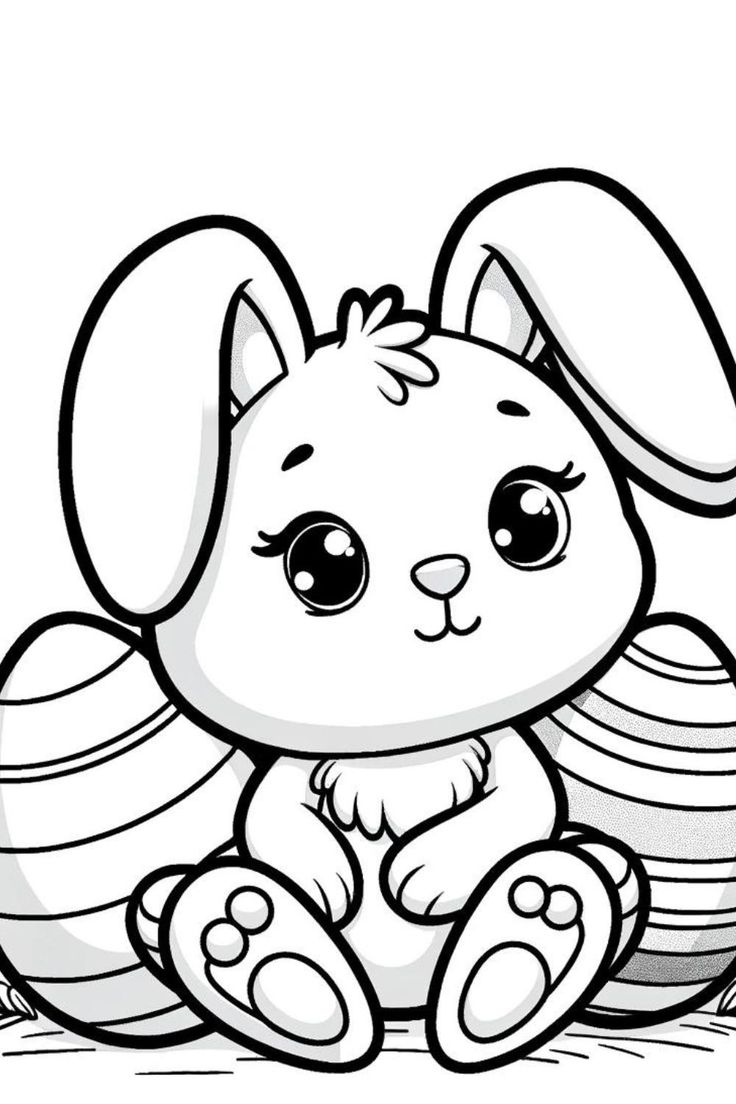 a cute little bunny sitting on top of some stacked easter eggs with her ears sticking out