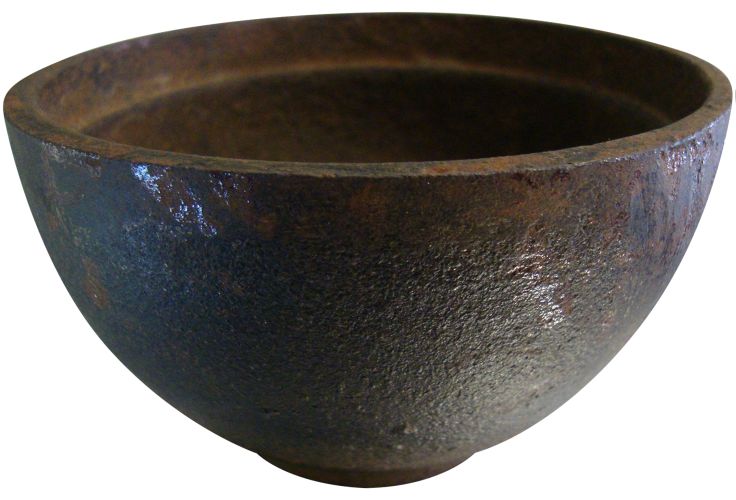 a large metal bowl sitting on top of a white surface