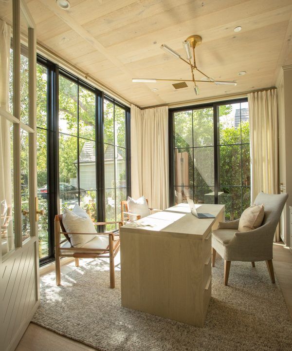 a living room filled with furniture and lots of windows