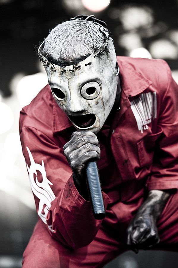 a man wearing a mask and holding a microphone