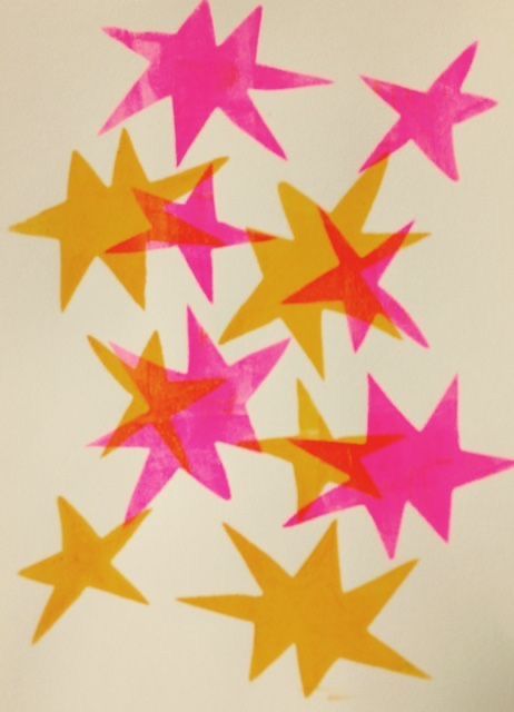 pink and yellow stars are arranged in the shape of a star on a white background