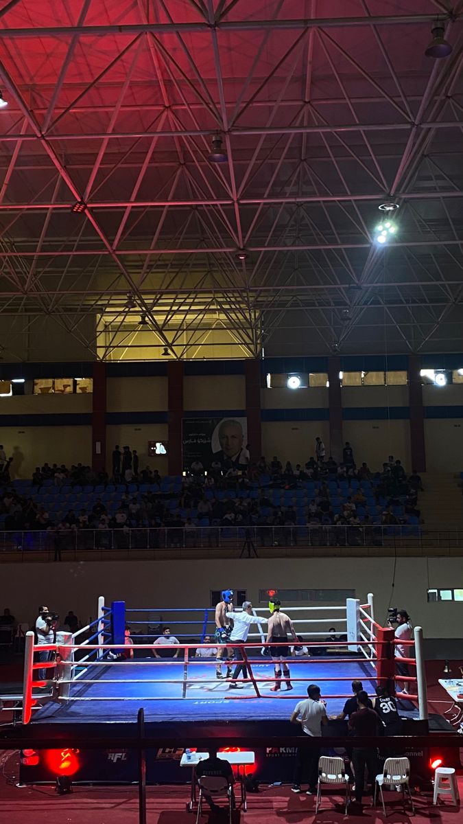 two boxers are in the ring during a boxing match