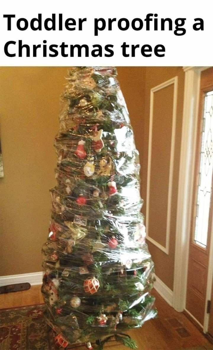 a christmas tree made out of plastic bags and wrapped around it with the words toddler proofing a christmas tree