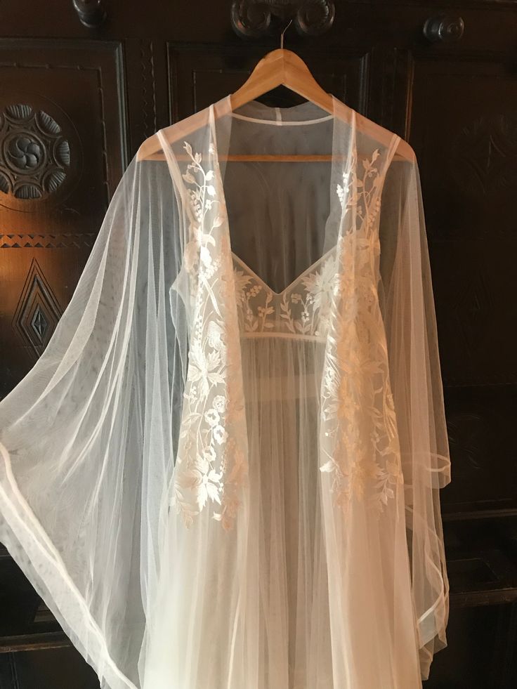 Magnificent see-through robe with long wide draped sleeves embroidered with lace. There is no better choice for a wedding night or honeymoon. The look is completed with the long matching nightgown. #sheerrobe #seethroughlibgerie #longbridalrobe #boudoirphoto #romanticlingerie #nightwear #weddinglingerie #sleepwear #lacelingerie #weddinggowns #bridaldresses #bridallingerie #bridalshowergifts #bridalrobes #blacklingerie #роскошноебелье Lingerielook Outfit Wedding Night, Night Dress With Robe, Wedding Honeymoon Outfits, Nighty Night Dress For First Night, Nightgowns For Women Honeymoon, Wedding Linger Honeymoon, Organza Nightgown, Wedding Night Robe, Bridal Nightwear Wedding Night