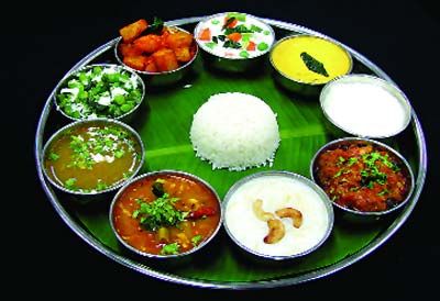 a platter filled with different types of food on top of a green leafy plate