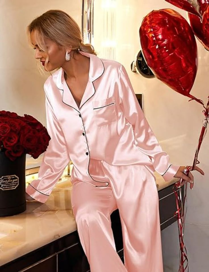 Experience the fusion of elegance with our satin pajama set. Designed for those who seek a graceful yet comfortable garment for their night-time ritual or casual day wear, this set is a versatile addition to any wardrobe. Product Features: Material Excellence: This set is made with high-grade satin, offering a breathable-and lightweight experience, and ensuring tranquil rest. Versatile Top: The pajama top is styled to transition seamlessly from a sleepwear piece to a chic casual outfit when pair Elegant Satin Sleepwear For Pajama Party, Pink Satin Home Sets, Satin Long Sleeve Bedtime Sets, Long Sleeve Satin Bedtime Sets, Satin Long Sleeve Sets For Wedding Night, Long Sleeve Satin Sets For Wedding Night, Feminine Satin Sleepwear Sets, Feminine Satin Sleepwear For Home, Feminine Satin Sleepwear