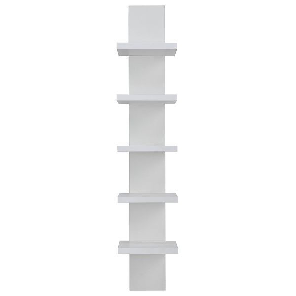 a tall white shelf sitting on top of a wall