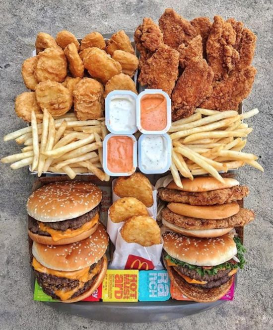 a tray filled with lots of different types of food next to french fries and chicken nuggets