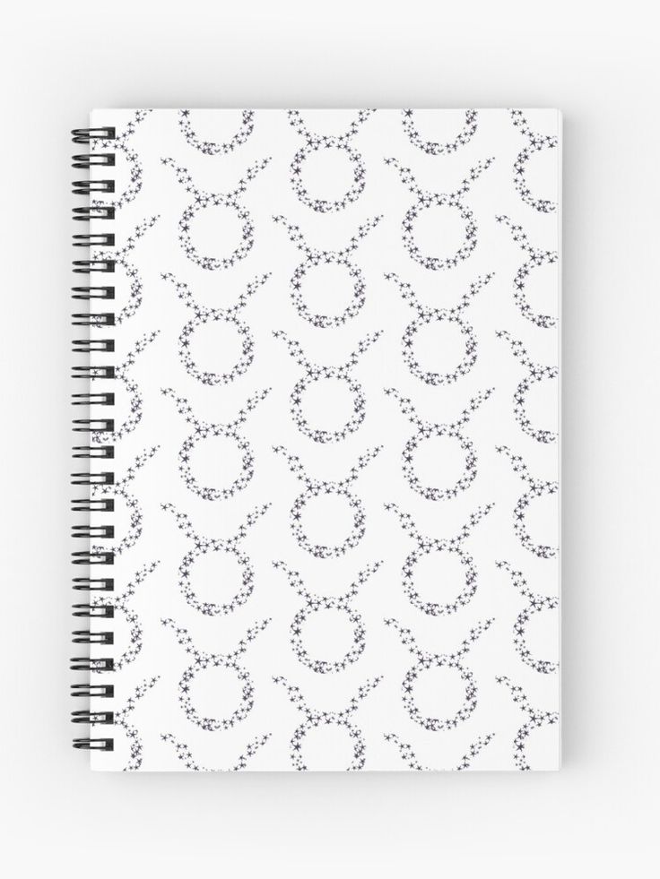 a spiral notebook with black and white circles on it