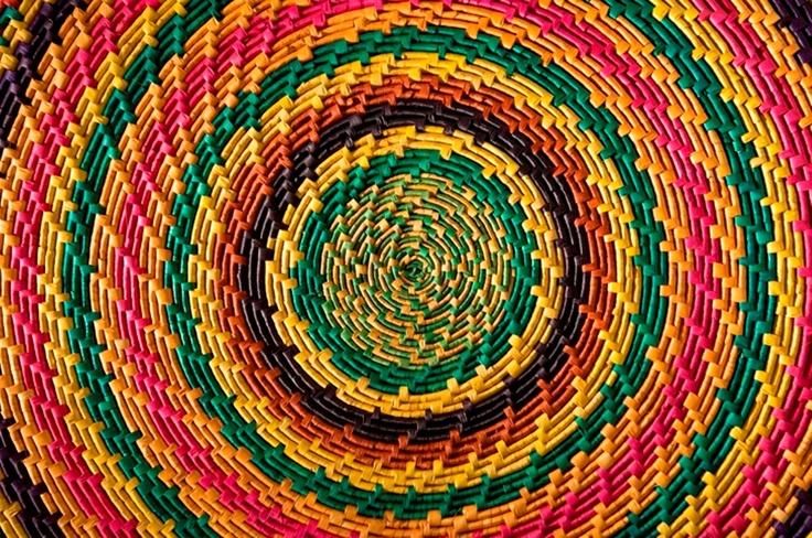 a colorful woven basket is shown in the middle of it's circular design, with different colors