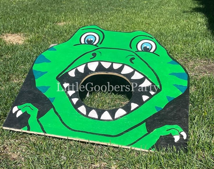 a cardboard cutout of a green alligator with its mouth open