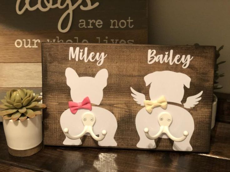 two wooden signs with little dogs on them