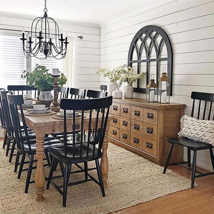 the dining room table is set with black chairs