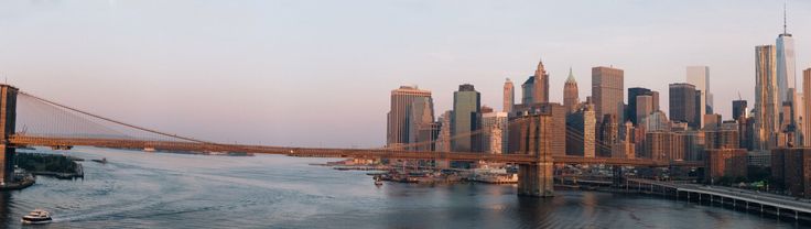 an aerial view of the brooklyn bridge and lower manhattan