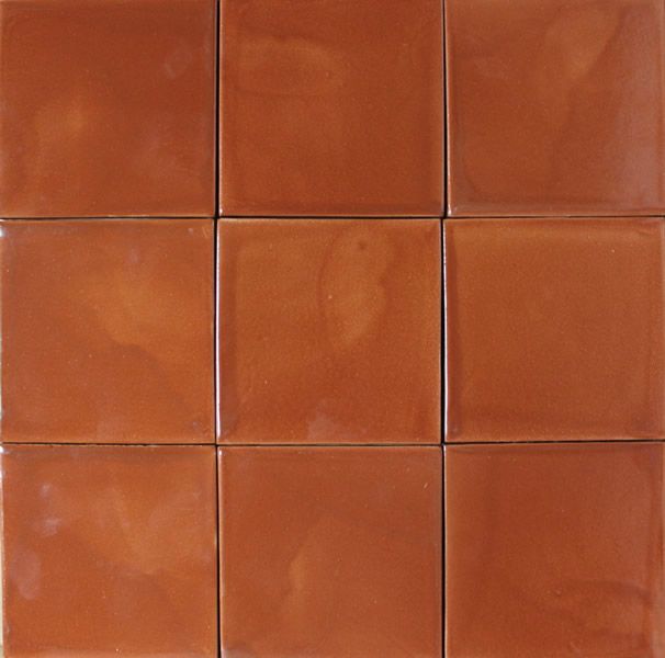 a brown tile wall with several different sized tiles