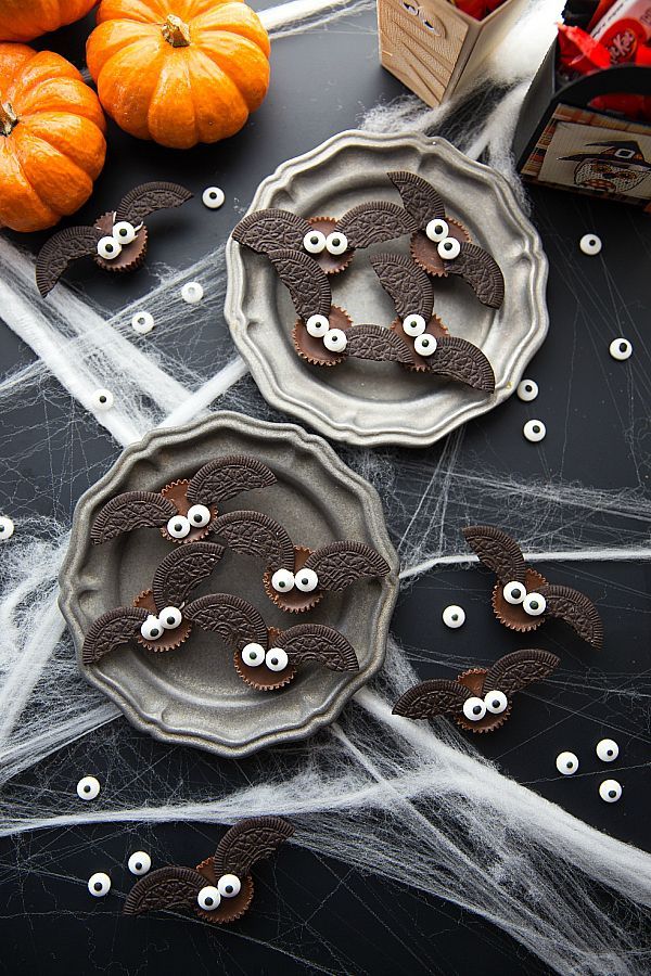 two plates with googly eyes on them and spider webs attached to the plates