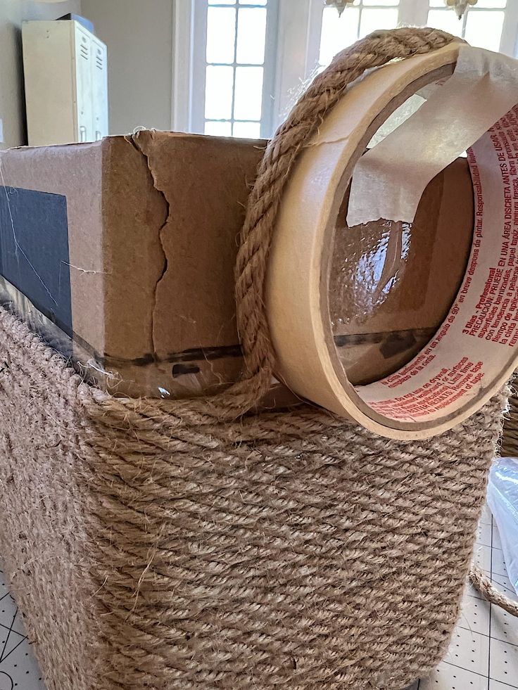 the inside of a basket with some tape on it and another item wrapped in jute